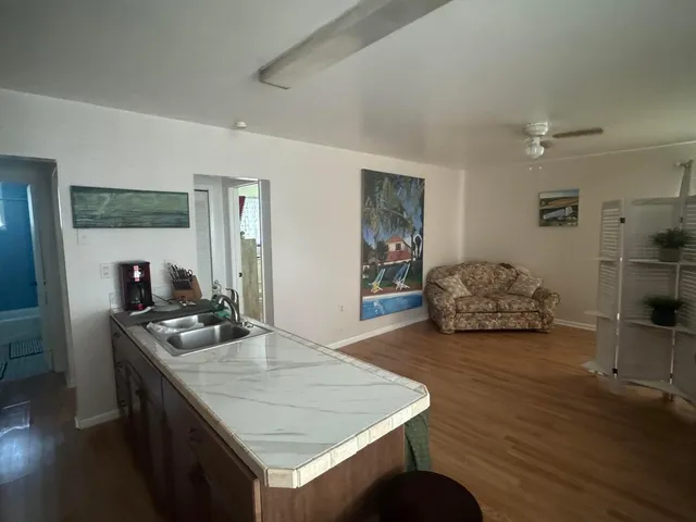 a kitchen with sink refrigerator and stove