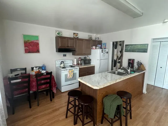 a kitchen with a dining table and chairs