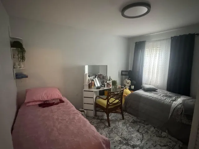 a bedroom with a bed and chair