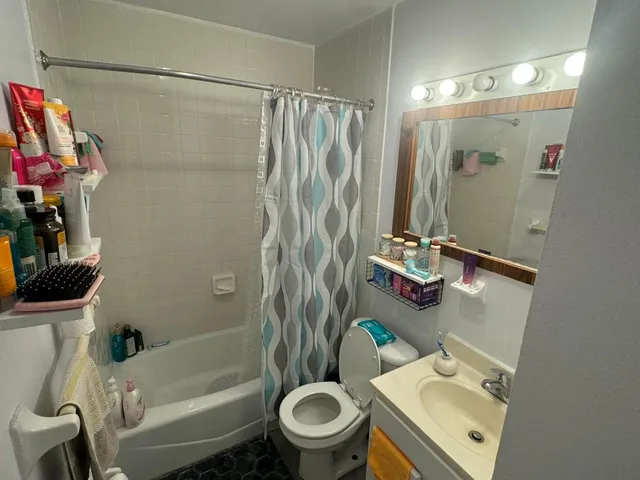 a bathroom with a sink toilet and shower