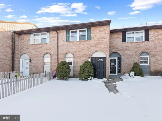 a front view of a house with yard