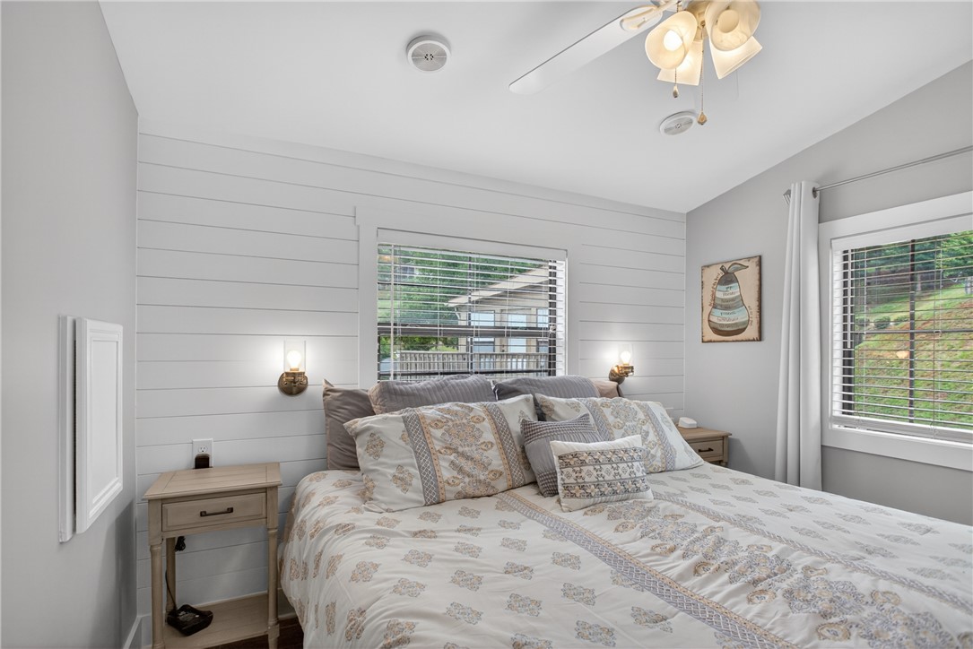 1230 Melton Road, Unit 4 West Union, SC 29696 - Photo 27 of 48 A comforting bedroom with shiplap walls and ample natural light, creating a serene personal retreat.