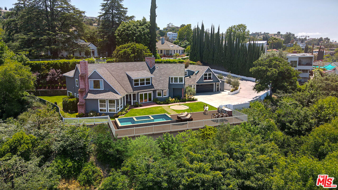 an aerial view of a house with swimming pool big yard and outdoor seating