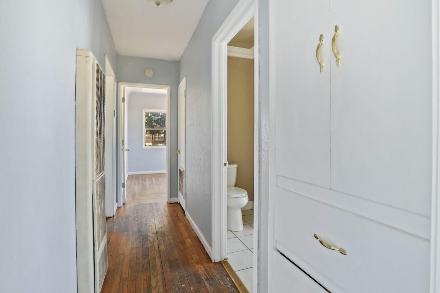 916 Elm Avenue Modesto, CA 95351 - Photo 22 of 52 23. Hallway view A simple hallway connects the home’s spaces with those original hardwood floors carrying the charm from room to room.