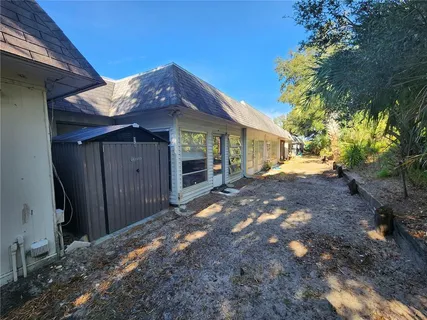 a view of a house with a small yard and floor to ceiling window