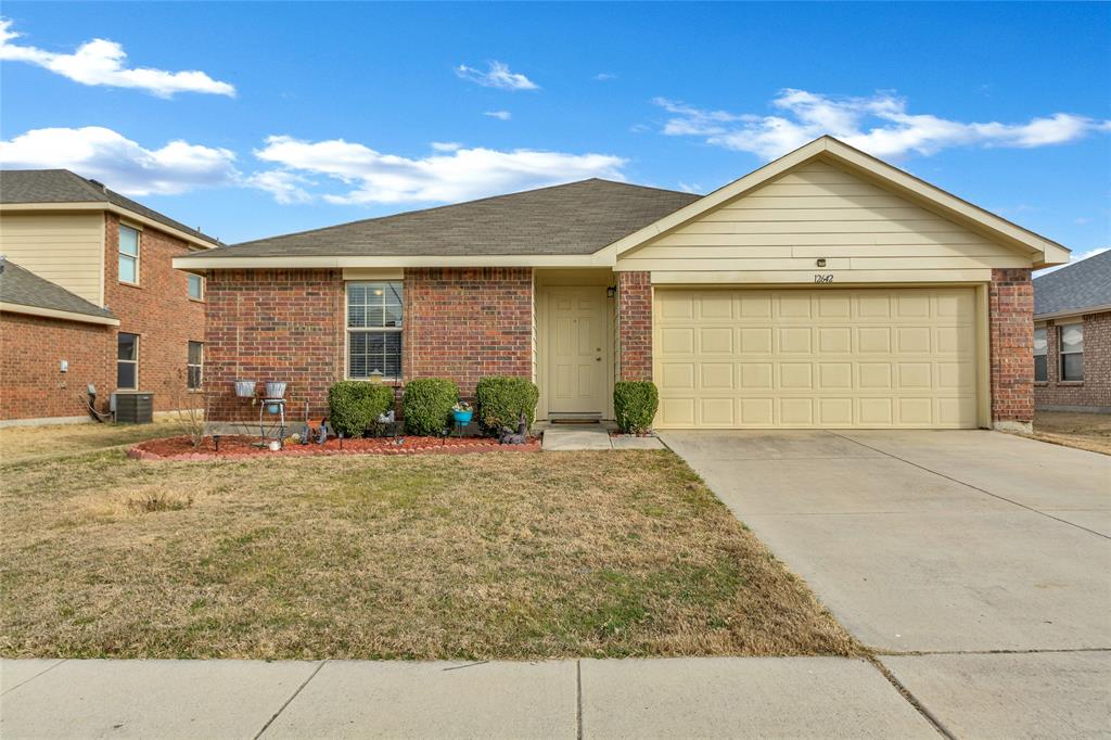 12642 Forest Lawn Road Rhome, TX 76078 - Photo 1 of 1 a front view of a house with a yard and garage