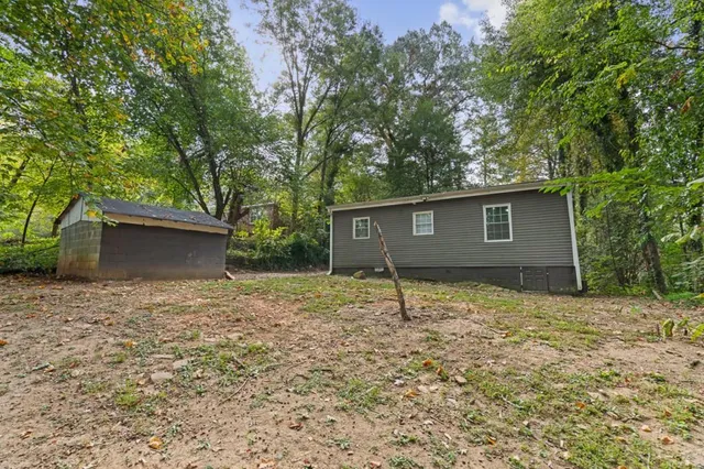 a house covered with tall trees
