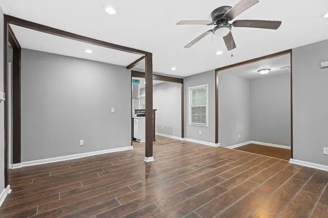 a view of an empty room with wooden floor