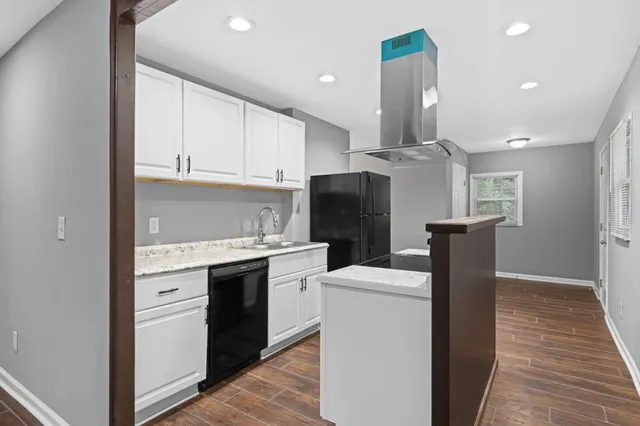a kitchen with stainless steel appliances a refrigerator sink and cabinets
