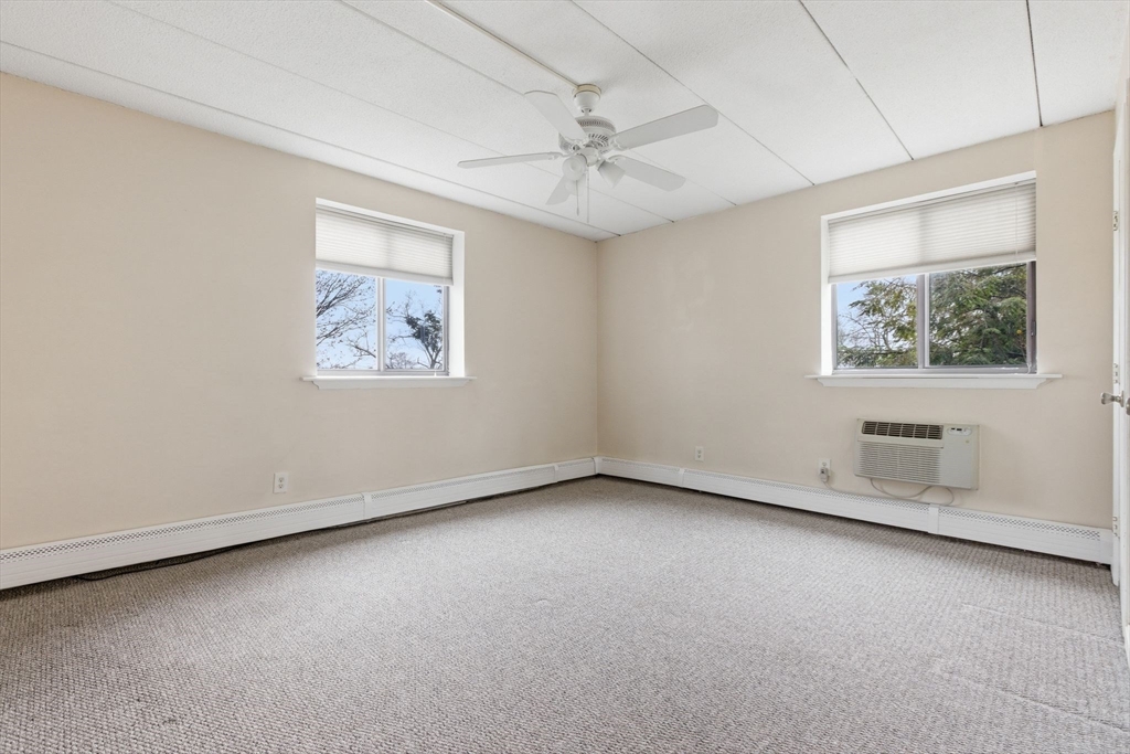 50 Water Street, Unit 46 Medford, MA 02155 - Photo 11 of 37 an empty room with a ceiling fan and window