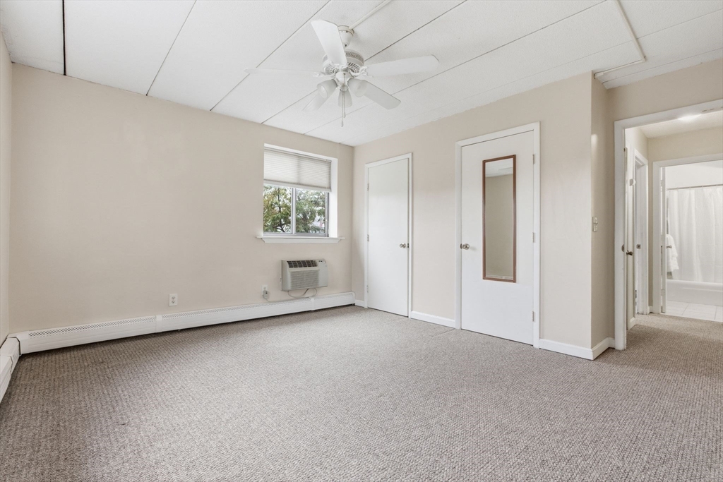 50 Water Street, Unit 46 Medford, MA 02155 - Photo 17 of 37 an empty room with windows and closet