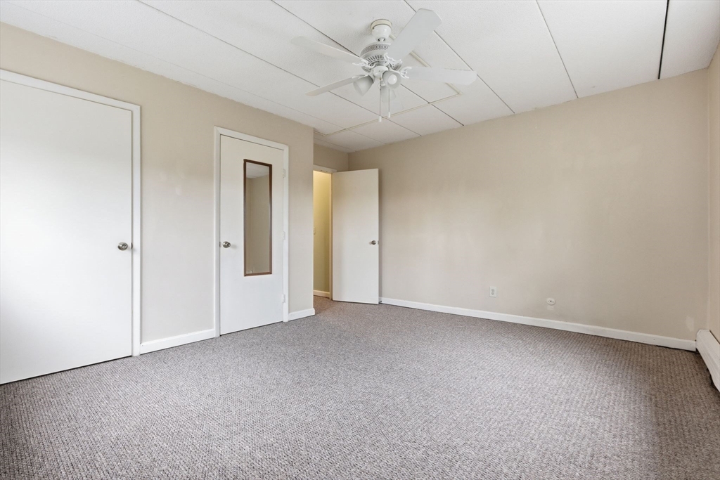 50 Water Street, Unit 46 Medford, MA 02155 - Photo 18 of 37 an empty room with a ceiling fan and window