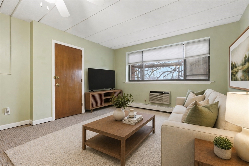 50 Water Street, Unit 46 Medford, MA 02155 - Photo 3 of 37 a living room with furniture and a flat screen tv