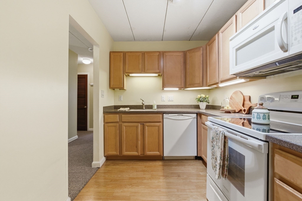 50 Water Street, Unit 46 Medford, MA 02155 - Photo 7 of 37 a kitchen with stainless steel appliances granite countertop a sink a stove a refrigerator and cabinets