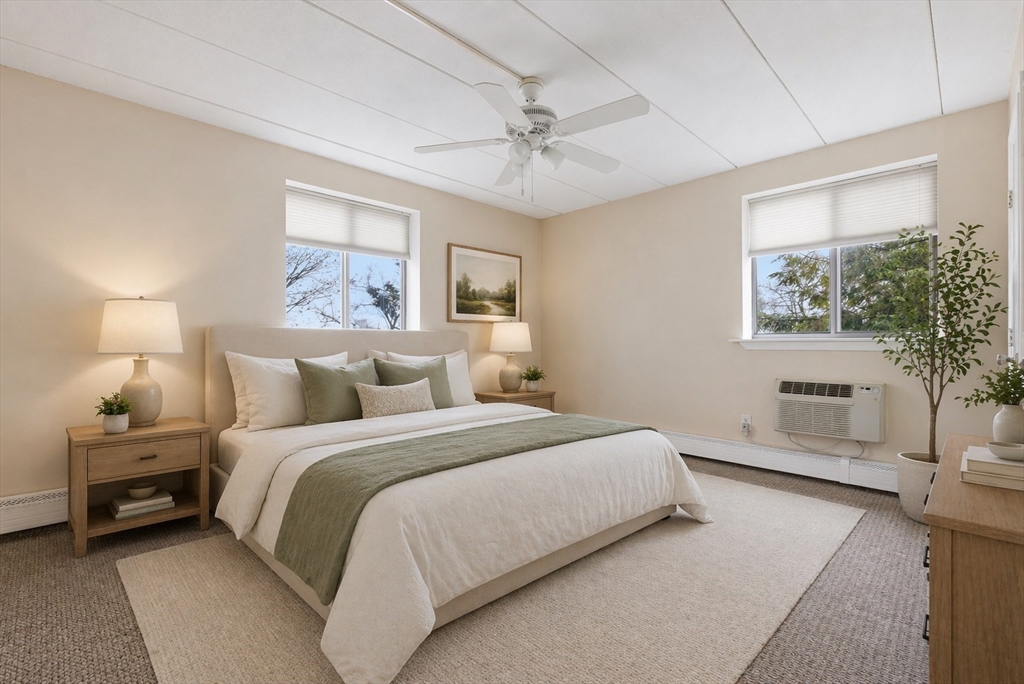 50 Water Street, Unit 46 Medford, MA 02155 - Photo 10 of 37 a bedroom with a large bed and a chandelier