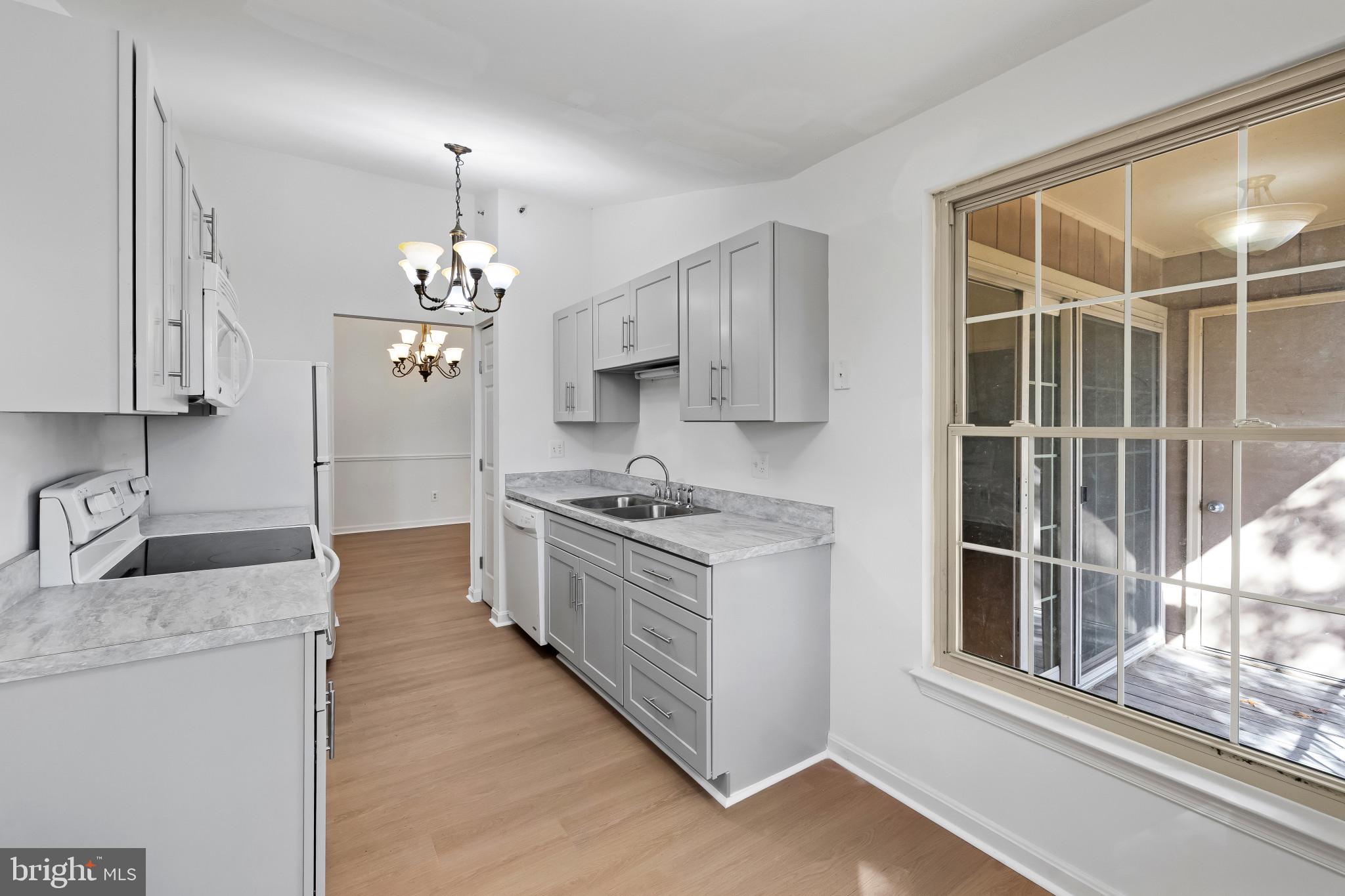 203 Star Pointe Court, Unit 3C Abingdon, MD 21009 - Photo 12 of 26 a kitchen with stainless steel appliances granite countertop a stove and a sink