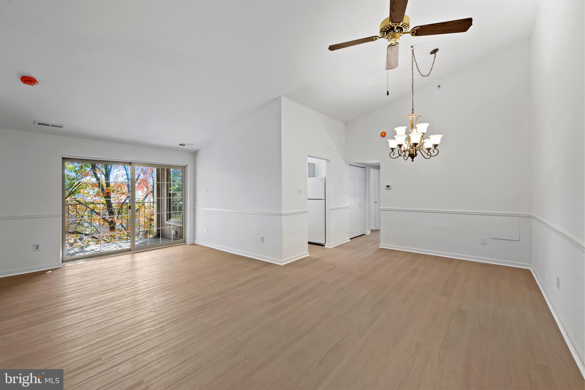 203 Star Pointe Court, Unit 3C Abingdon, MD 21009 - Photo 4 of 26 a view of an empty room with a window and wooden floor