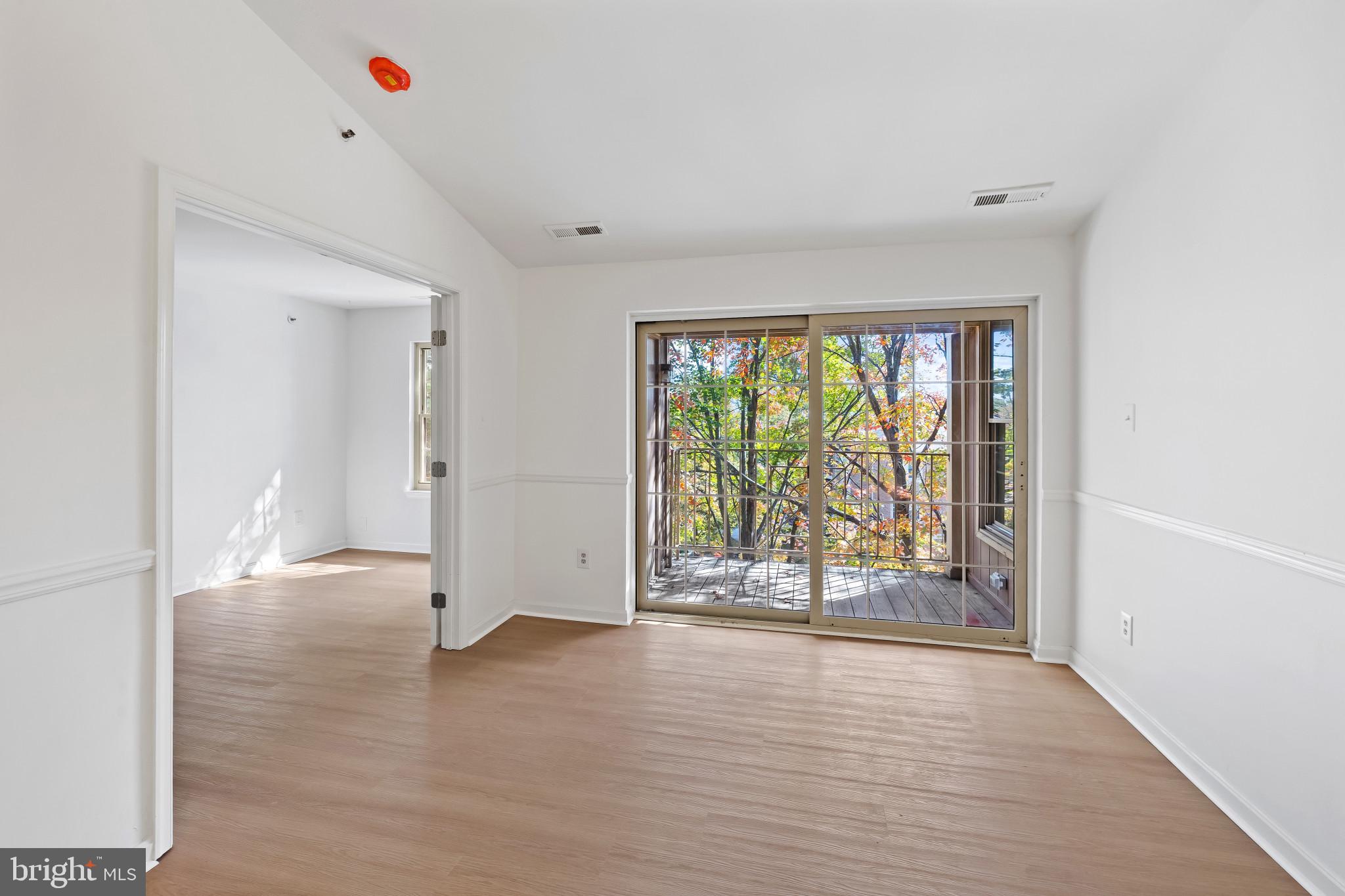 203 Star Pointe Court, Unit 3C Abingdon, MD 21009 - Photo 10 of 26 an empty room with wooden floor and windows