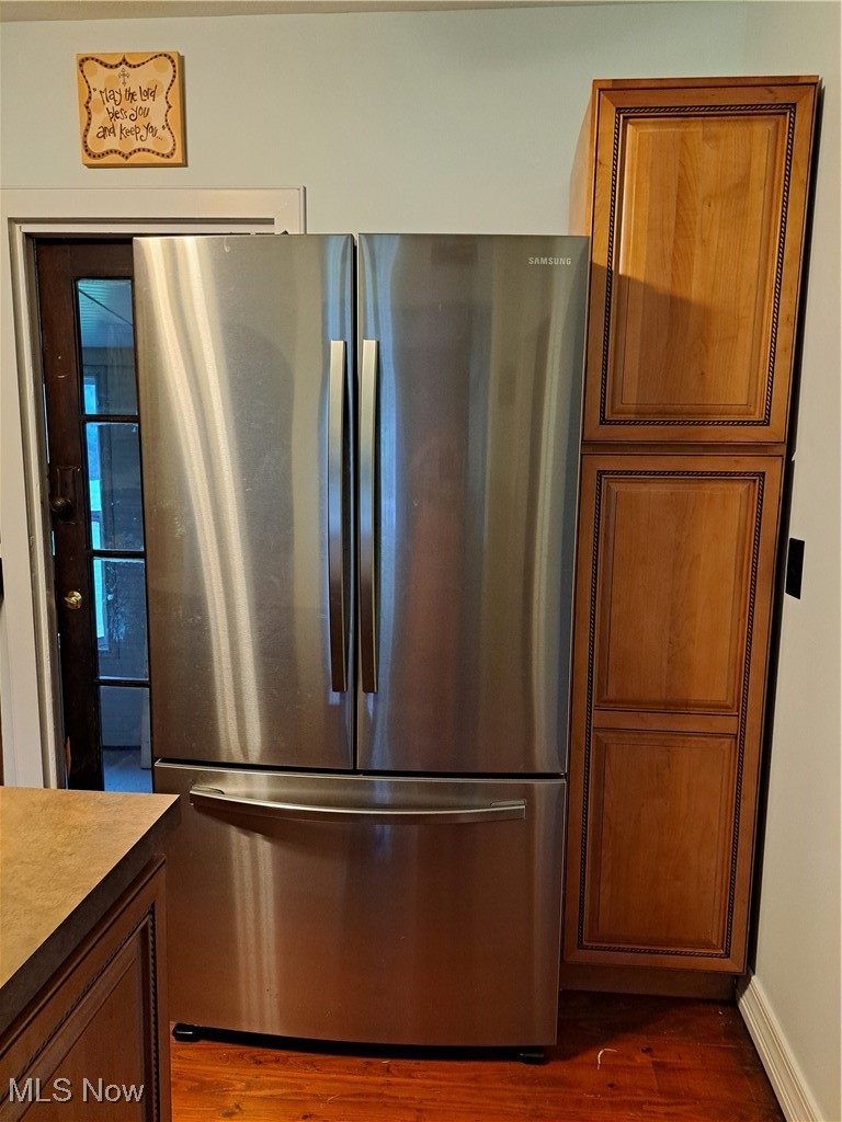 49197 John Tomcho Road Cumberland, OH 43732 - Photo 21 of 50 Kitchen featuring dark hardwood / wood-style flooring and stainless steel refrigerator