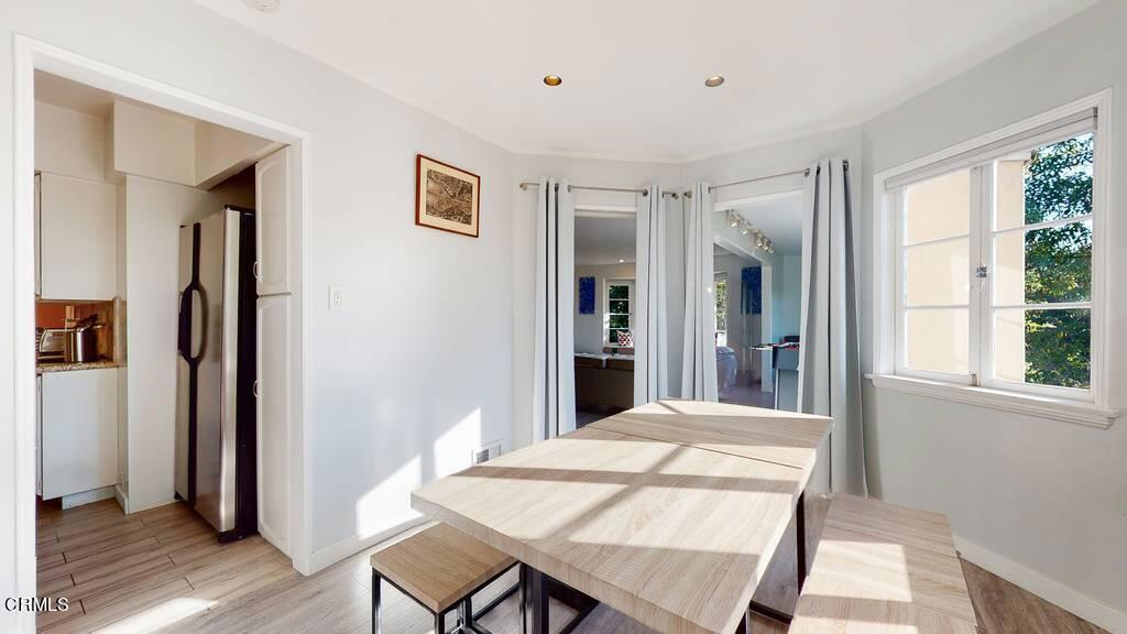 101 South Rockingham Avenue Los Angeles, CA 90049 - Photo 12 of 44 a view of a dining room with furniture window and wooden floor