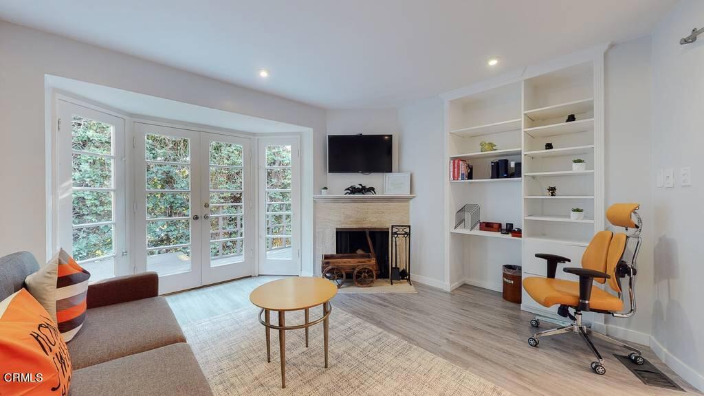 101 South Rockingham Avenue Los Angeles, CA 90049 - Photo 17 of 44 a living room with furniture and a fireplace