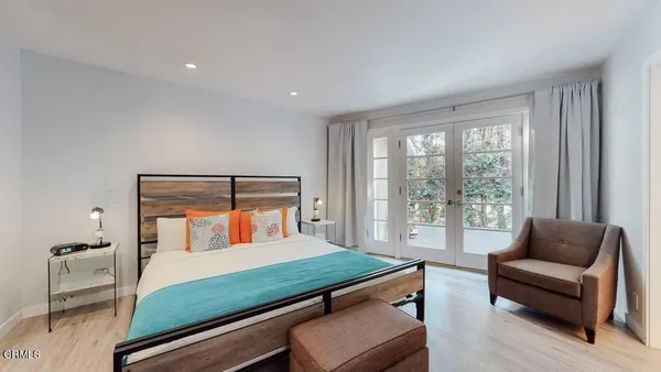 a large white room with a sink and mirror