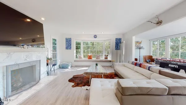 a living room with fireplace furniture and a flat screen tv