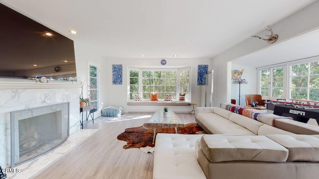 101 South Rockingham Avenue Los Angeles, CA 90049 - Photo 3 of 44 a living room with furniture and a fireplace