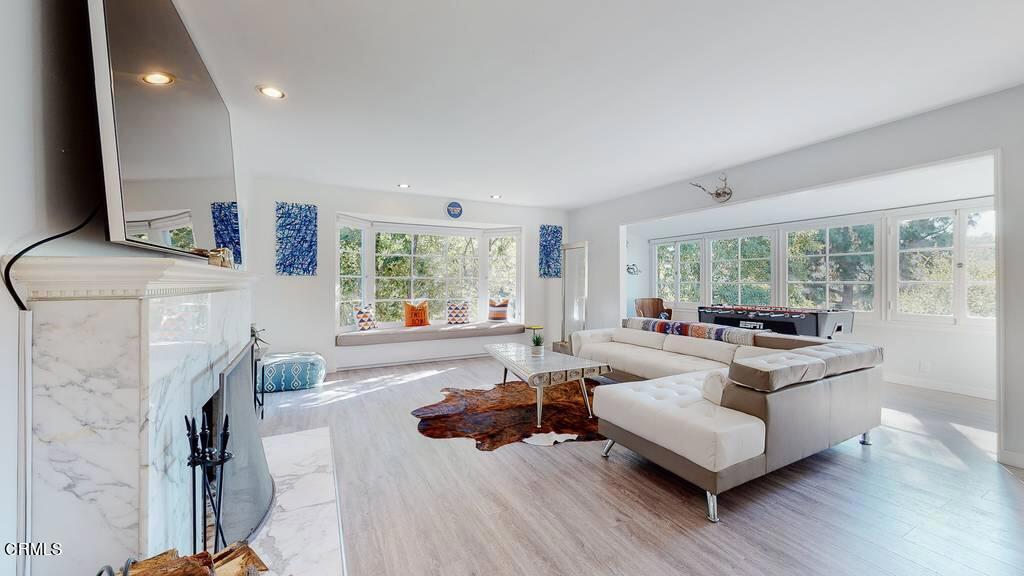 101 South Rockingham Avenue Los Angeles, CA 90049 - Photo 8 of 44 a living room with furniture and a fireplace