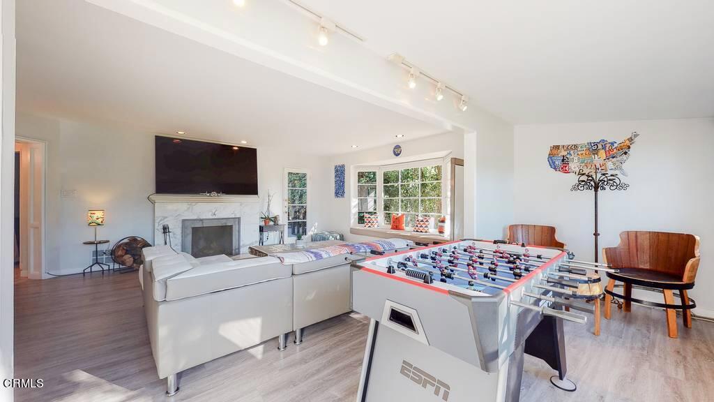 101 South Rockingham Avenue Los Angeles, CA 90049 - Photo 9 of 44 a living room with furniture a fireplace and a flat screen tv