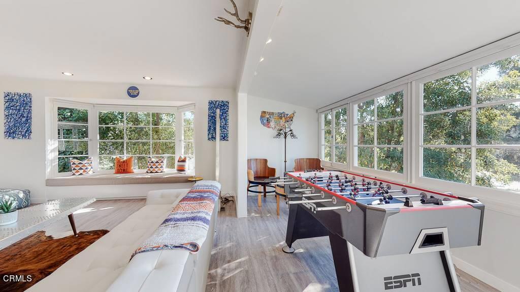 101 South Rockingham Avenue Los Angeles, CA 90049 - Photo 10 of 44 a living room with furniture and large windows