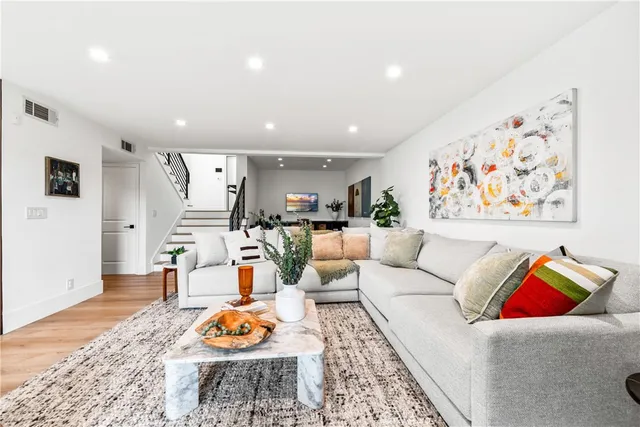 a living room with furniture a fireplace and a floor to ceiling window