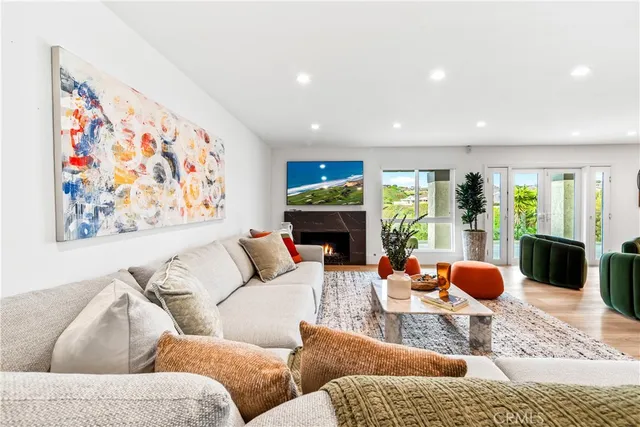 a bedroom with furniture and a large window