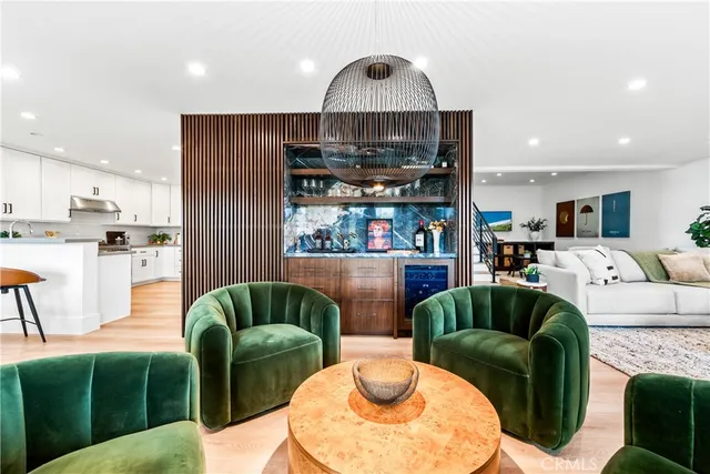 a kitchen with stainless steel appliances kitchen island wooden floors and white cabinets