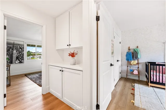 a spacious bedroom with a bed a mirror and couch