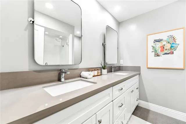 a bathroom with a glass shower door and a window