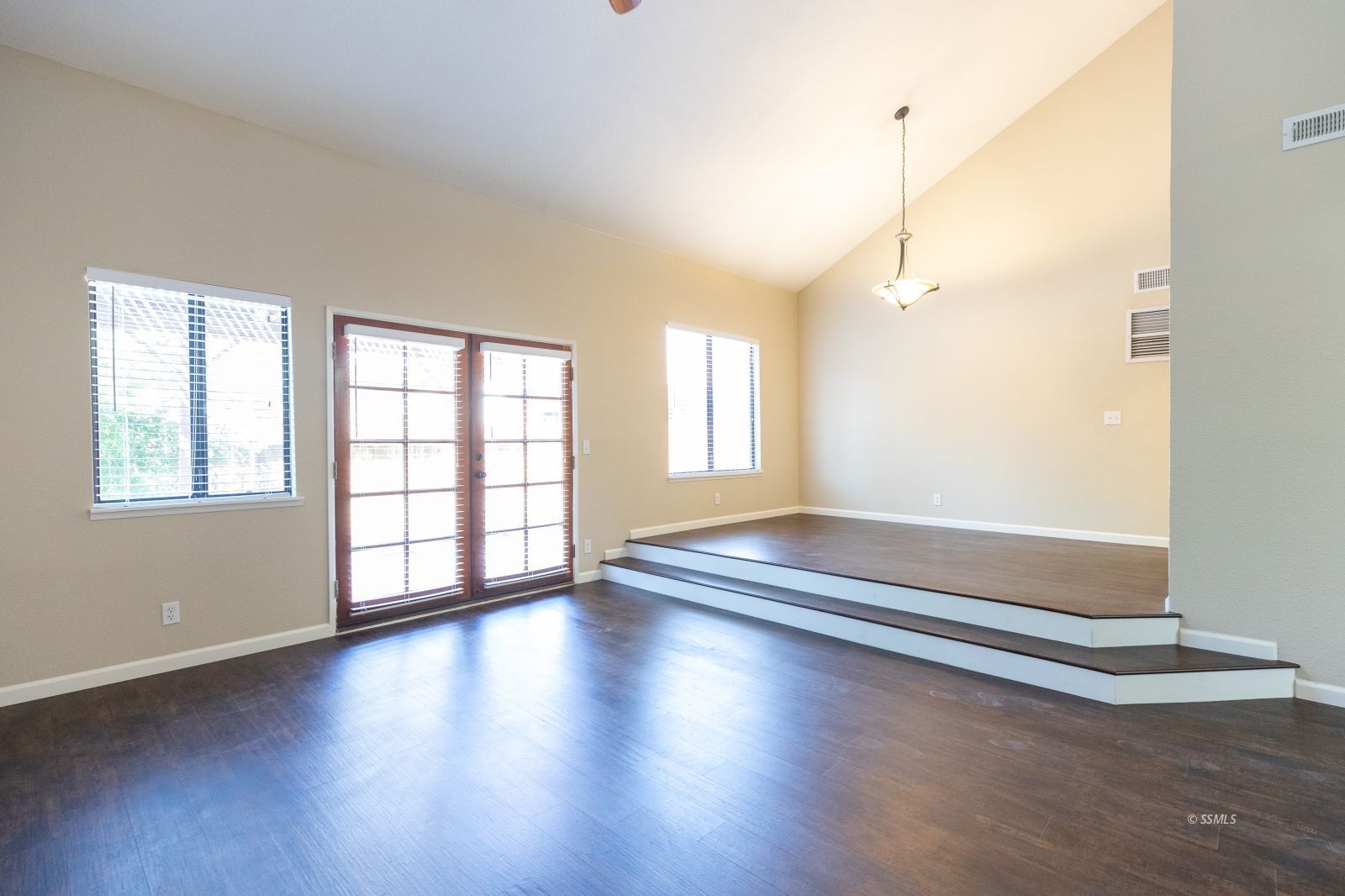 418 Tepatitlan Court Ridgecrest, CA 93555 - Photo 7 of 40 an empty room with wooden floor and windows