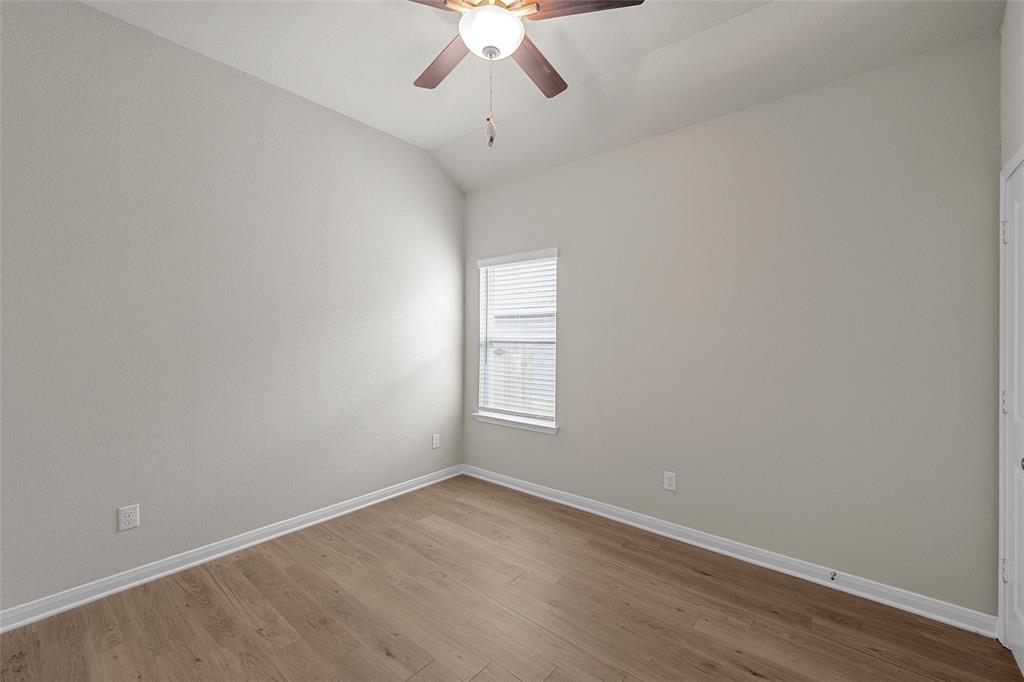 3224 Dottavio Road Lorena, TX 76655 - Photo 16 of 31 Room with wood-finish flooring, neutral wall paint, and a ceiling fan with light fixture