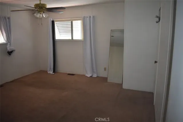 an empty room with windows and entrance