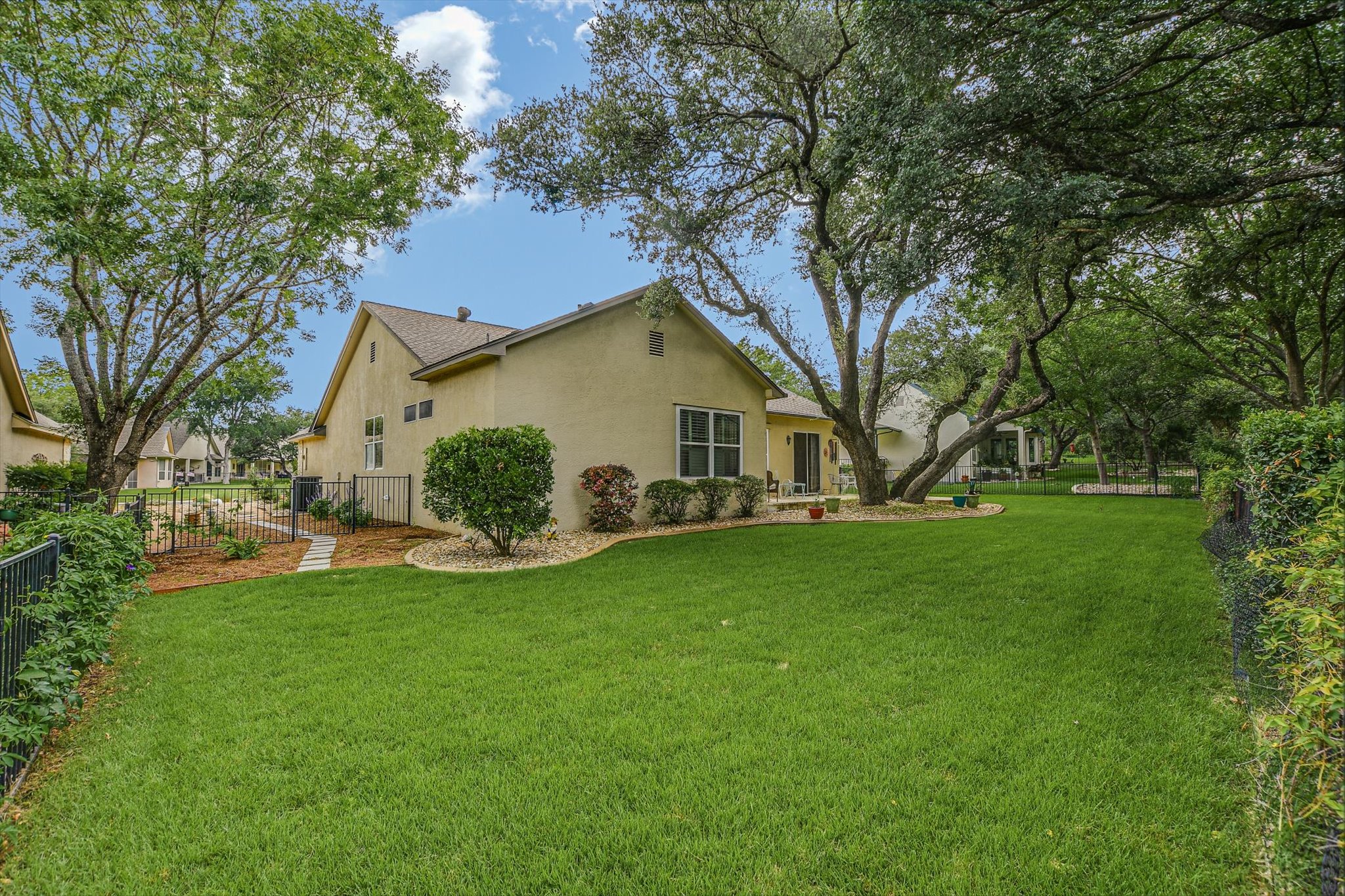 106 Nighthawk Way Georgetown, TX 78633 - Photo 29 of 29 A well-maintained lawn and mature trees frame this residence, offering a serene outdoor retreat.