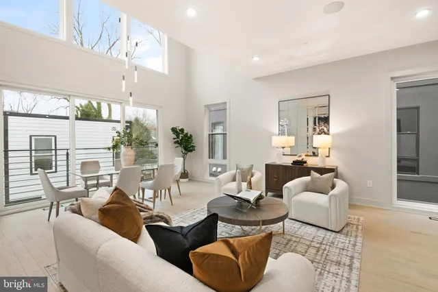 a living room with furniture flowers and a chandelier