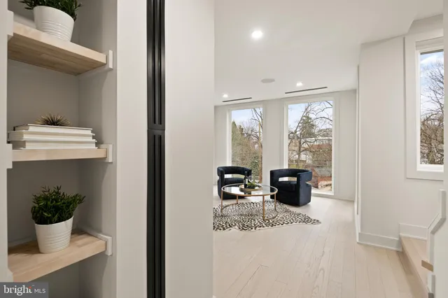 a spacious bedroom with a large bed and a large window