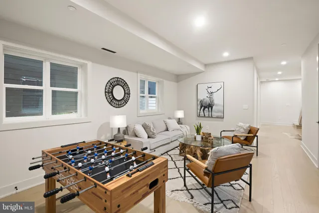 a bathroom with a bathtub shower sink vanity mirror and toilet