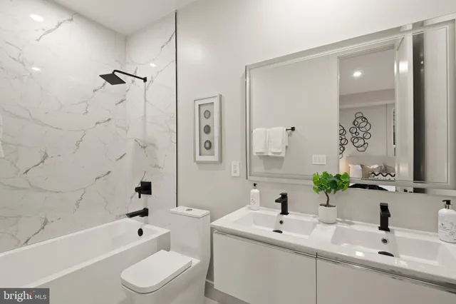 a bathroom with a sink mirror toilet and bathtub