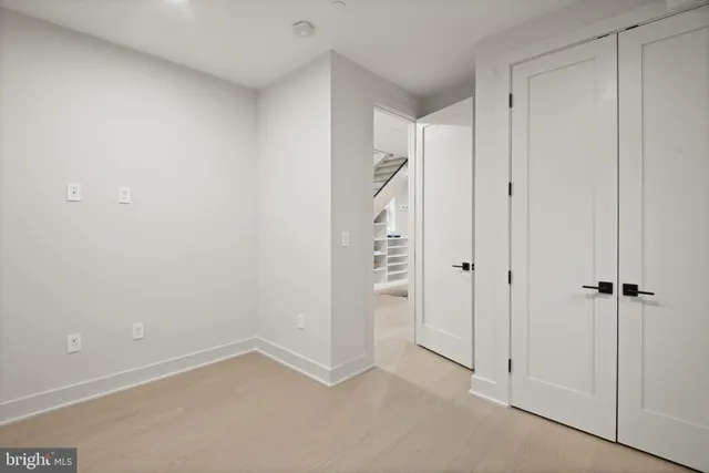 a kitchen with a refrigerator and a stove top oven