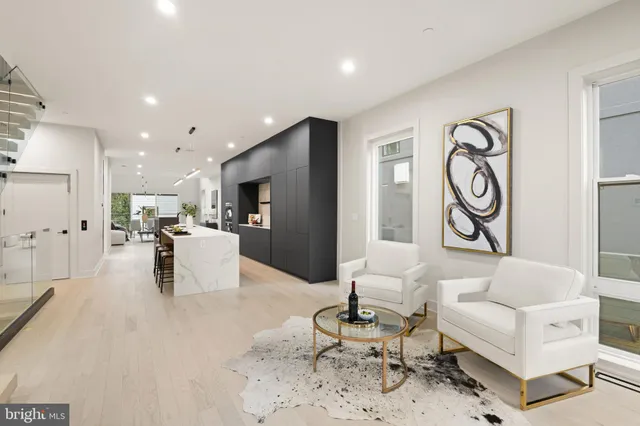 a living room with furniture and kitchen view