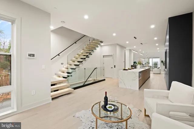 a large kitchen with kitchen island a sink stainless steel appliances and a counter top space