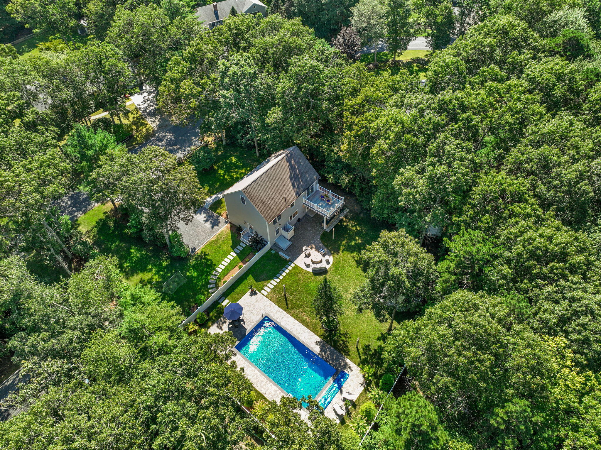 an aerial view of a house with a yard and swimming pool