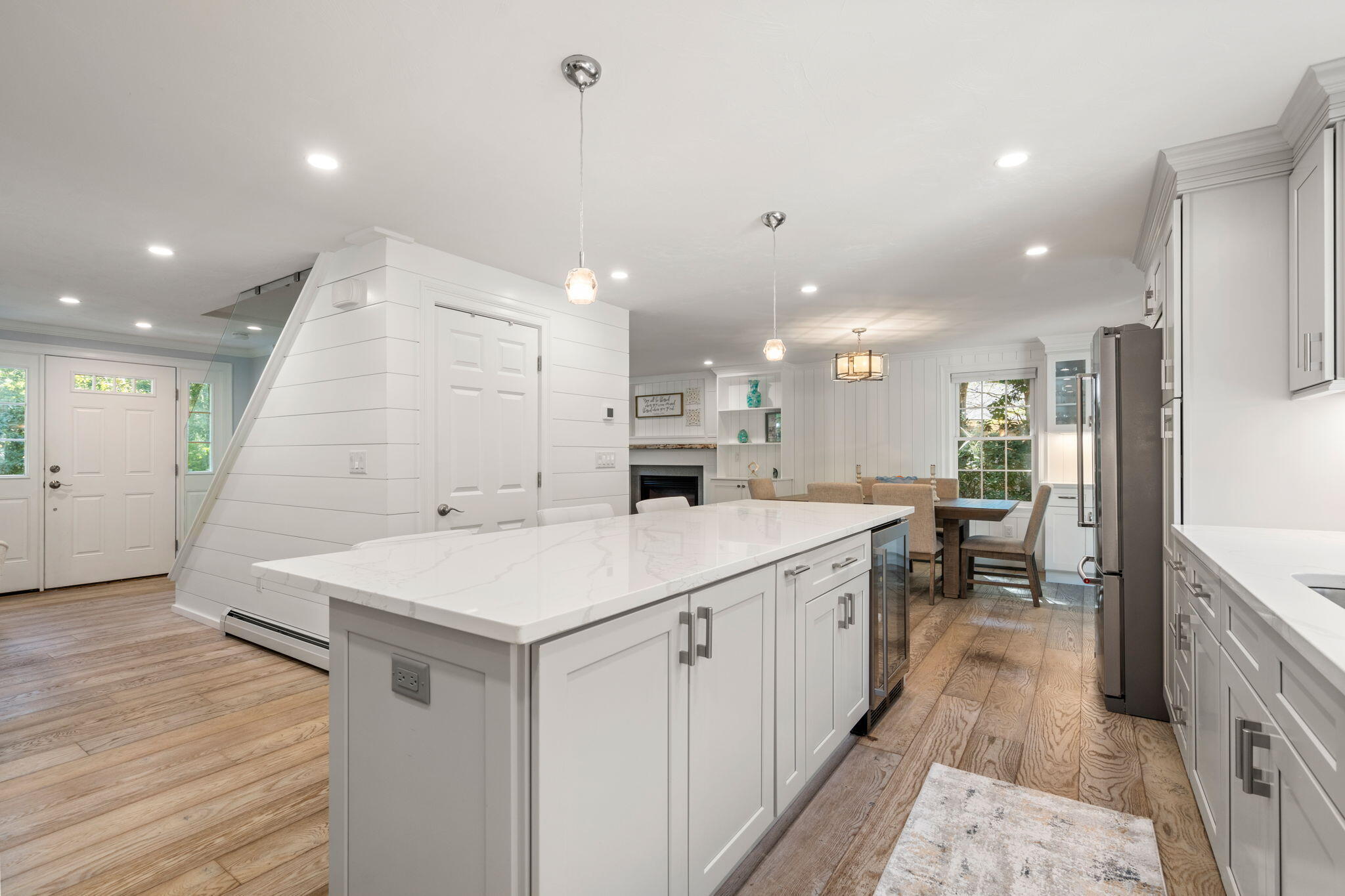41 Old Fields Road Sandwich, MA 02563 - Photo 11 of 47 a large kitchen with kitchen island a sink a center island a stove a dining table and chairs