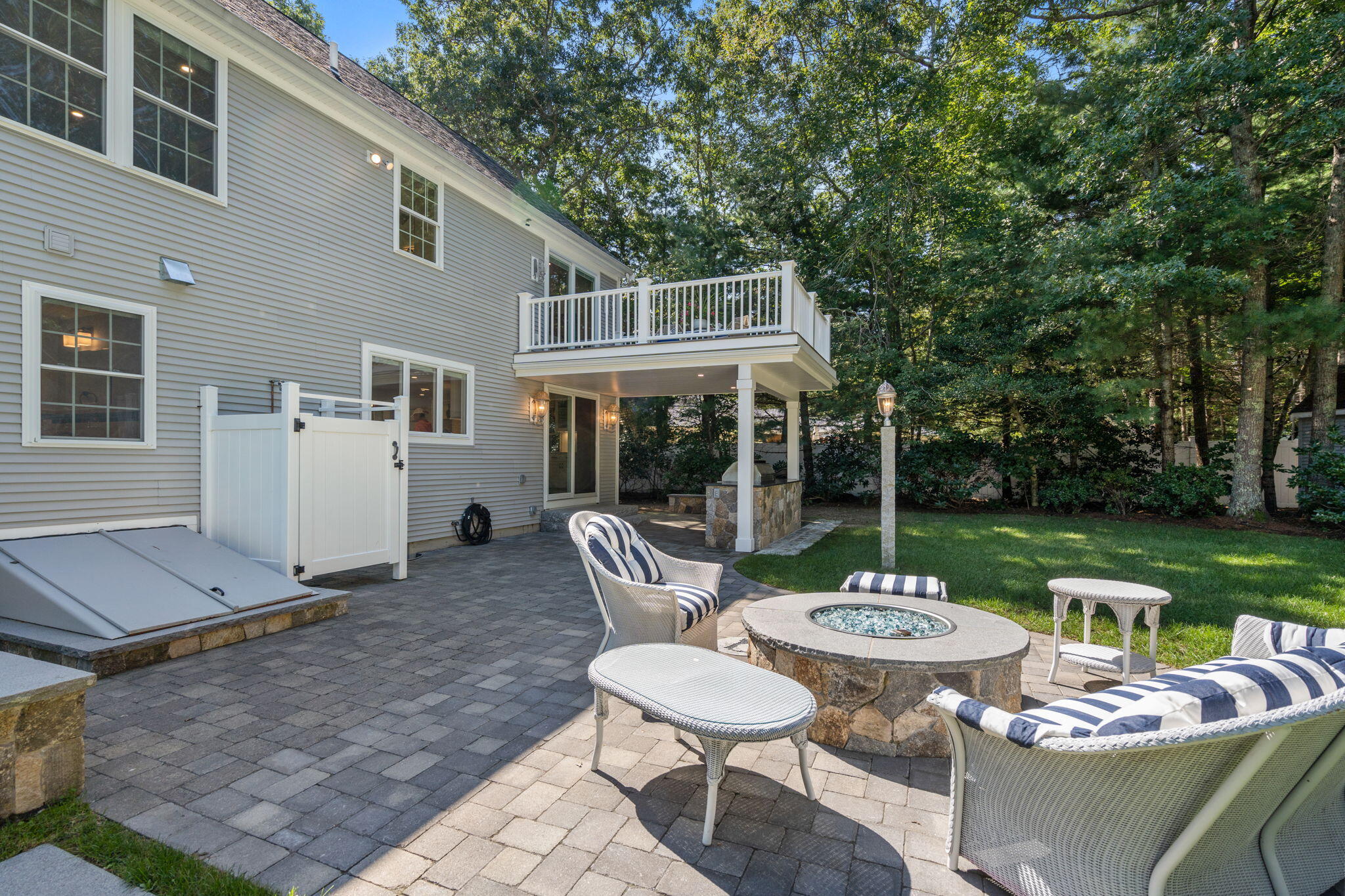41 Old Fields Road Sandwich, MA 02563 - Photo 32 of 47 a view of a patio with a dining table and chairs